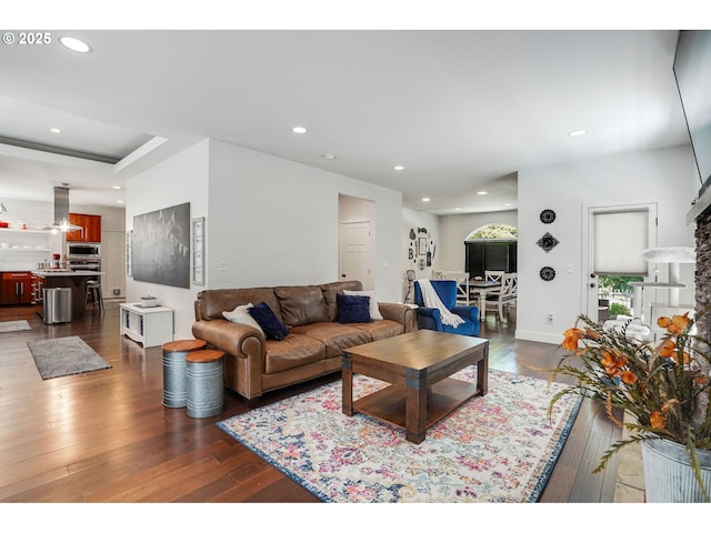 living room featuring recessed lighting, baseboards, and dark wood finished floors