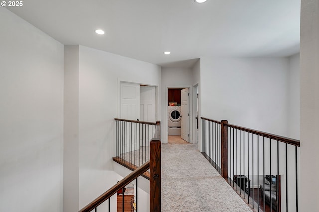 corridor with washer / clothes dryer, recessed lighting, carpet flooring, and an upstairs landing