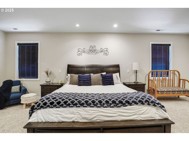 carpeted bedroom with visible vents and recessed lighting