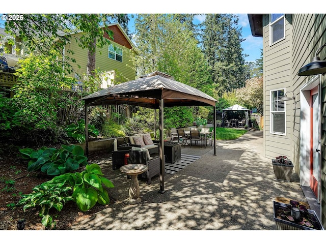 view of patio with outdoor dining space and a gazebo