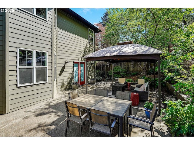 view of patio / terrace featuring french doors, outdoor dining area, and a gazebo