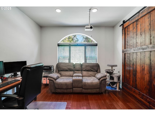 office with recessed lighting, a barn door, and wood finished floors