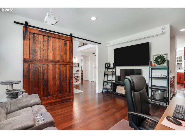 office space with recessed lighting, a barn door, and wood finished floors