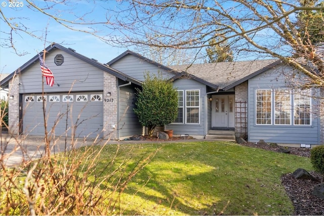 ranch-style home with a front yard and a garage