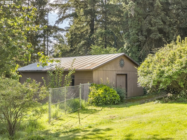 view of outdoor structure with fence and a gate