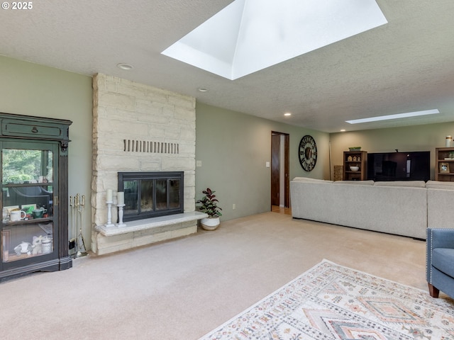 unfurnished living room with recessed lighting, a textured ceiling, carpet, and a skylight
