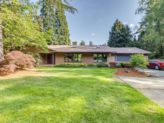 ranch-style house with an attached garage, brick siding, a front yard, a chimney, and concrete driveway