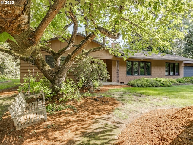exterior space featuring brick siding and roof with shingles