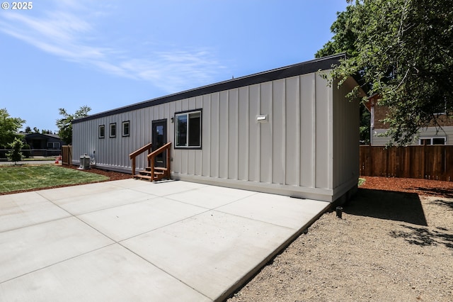 116 W J St, Springfield, OR 97477 - back of house with entry steps, board and batten siding, and a patio