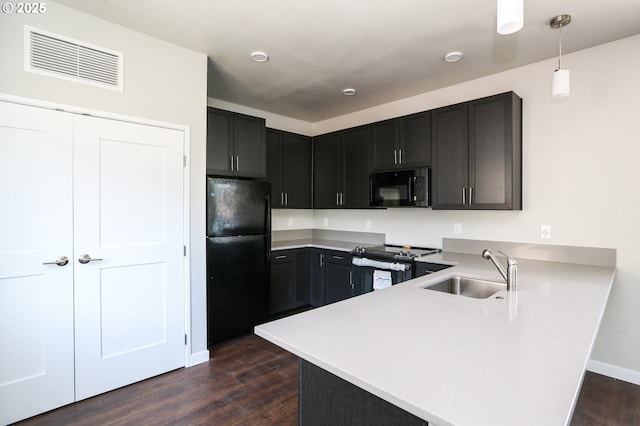 116 W J St, Springfield, OR 97477 - kitchen featuring black appliances, a peninsula, dark wood-style floors, and light countertops
