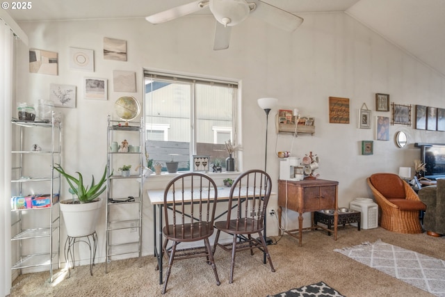 carpeted dining room featuring vaulted ceiling and ceiling fan