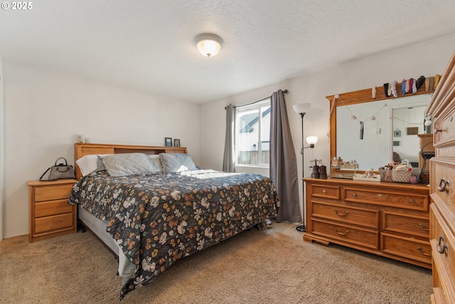 bedroom with light carpet and a textured ceiling