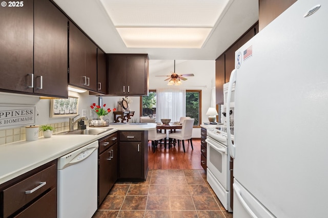14935 NE Sacramento St Unit 28, Portland, OR 97230 - kitchen featuring white appliances, light countertops, dark brown cabinetry, ceiling fan, and a peninsula