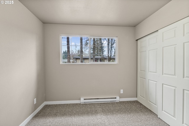 unfurnished bedroom featuring baseboard heating and carpet