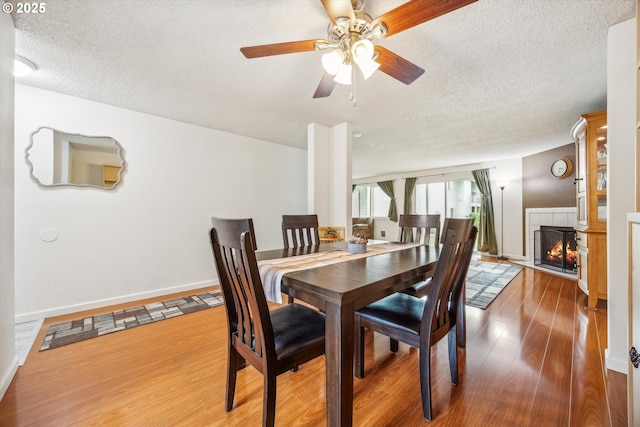 5160 SW 180th Ave Unit 17, Beaverton, OR 97078 - dining space featuring a textured ceiling, wood finished floors, a ceiling fan, and baseboards