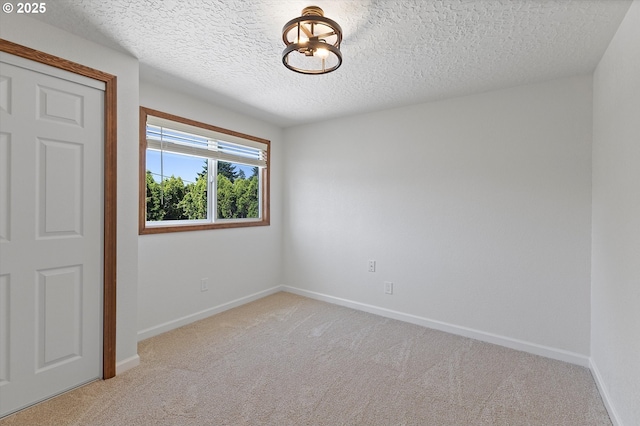 921 SE 168th Ave, Portland, OR 97233 - unfurnished bedroom featuring carpet flooring and a textured ceiling