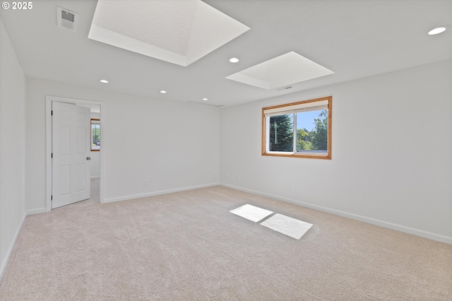 921 SE 168th Ave, Portland, OR 97233 - unfurnished room featuring a skylight, light carpet, plenty of natural light, and recessed lighting
