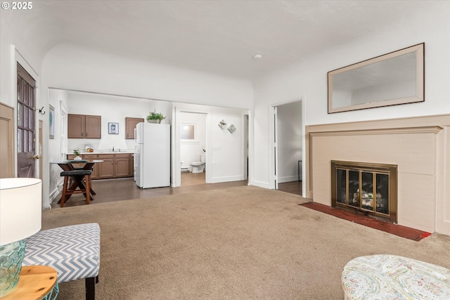 561 Madison St, Eugene, OR 97402 - living area featuring a fireplace and dark carpet