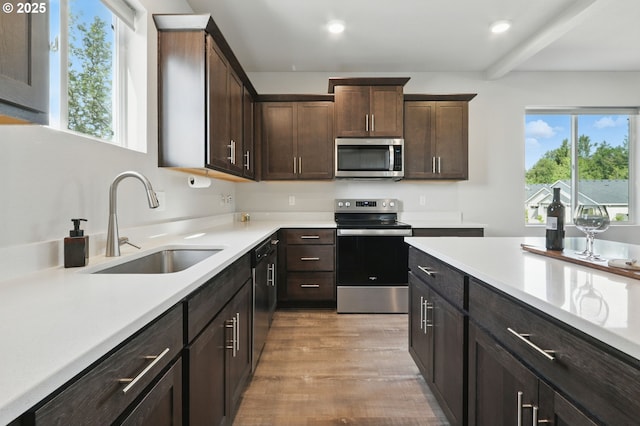 4236 E Willakenzie St, Newberg, OR 97132 - kitchen featuring stainless steel appliances, light wood-style flooring, light countertops, dark brown cabinetry, and recessed lighting