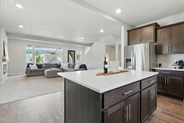 4236 E Willakenzie St, Newberg, OR 97132 - kitchen featuring stainless steel fridge with ice dispenser, wood finished floors, dark brown cabinetry, light countertops, and recessed lighting