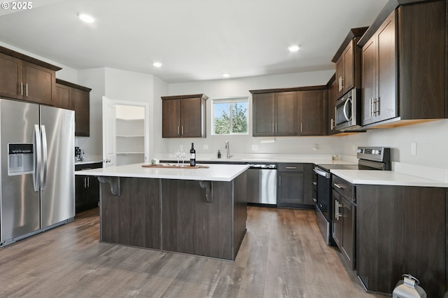 4236 E Willakenzie St, Newberg, OR 97132 - kitchen featuring stainless steel appliances, dark wood-style flooring, dark brown cabinetry, and recessed lighting