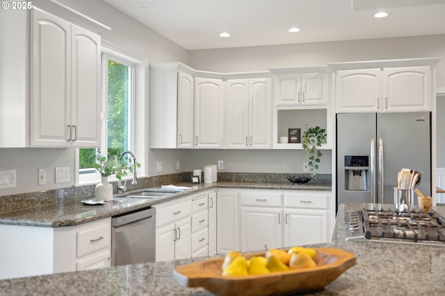 10695 SW Meier Dr, Tualatin, OR 97062 - kitchen with appliances with stainless steel finishes, white cabinets, dark stone counters, open shelves, and recessed lighting
