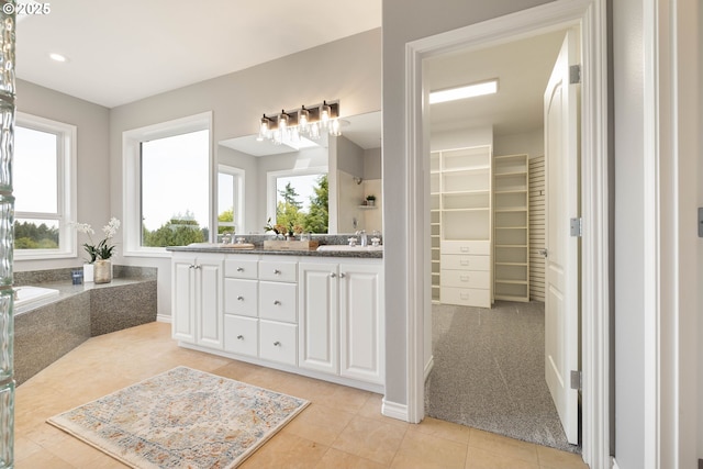 10695 SW Meier Dr, Tualatin, OR 97062 - bathroom featuring plenty of natural light, double vanity, a bathtub, and tile patterned flooring
