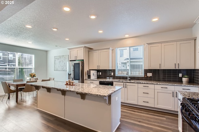 1319 S 29th Blvd, Cornelius, OR 97113 - kitchen featuring stainless steel fridge with ice dispenser, a sink, a kitchen breakfast bar, recessed lighting, and dark wood-type flooring