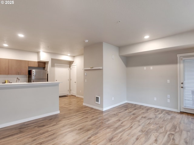 interior space with recessed lighting, light wood-type flooring, and baseboards