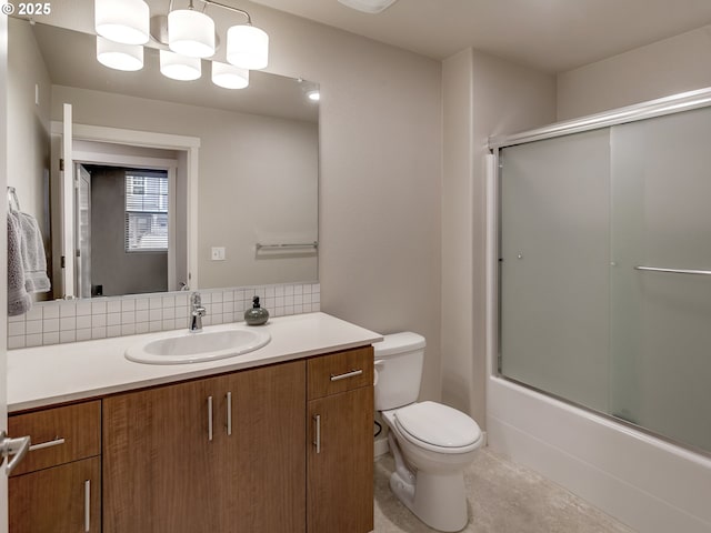 full bathroom featuring bath / shower combo with glass door, toilet, decorative backsplash, vanity, and tile patterned floors