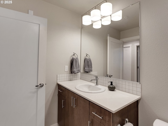 bathroom with vanity and decorative backsplash