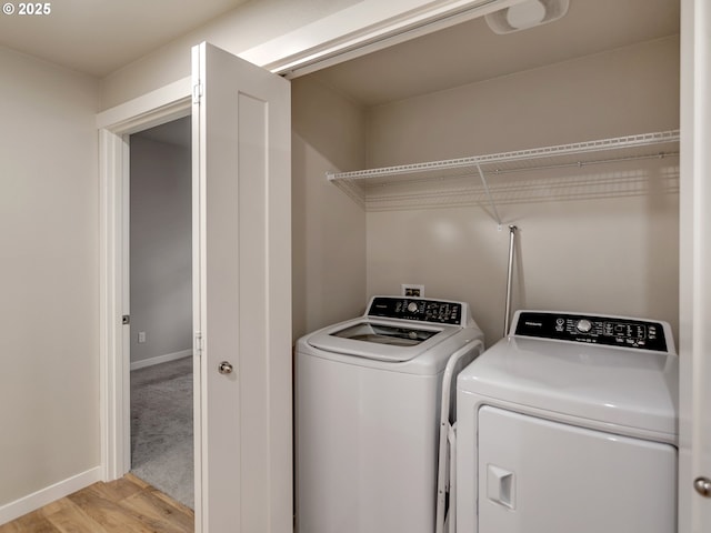 laundry room featuring baseboards, laundry area, separate washer and dryer, and light wood-style floors