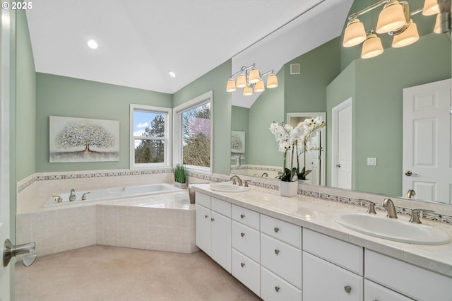 full bathroom featuring vaulted ceiling, a bath, double vanity, and a sink