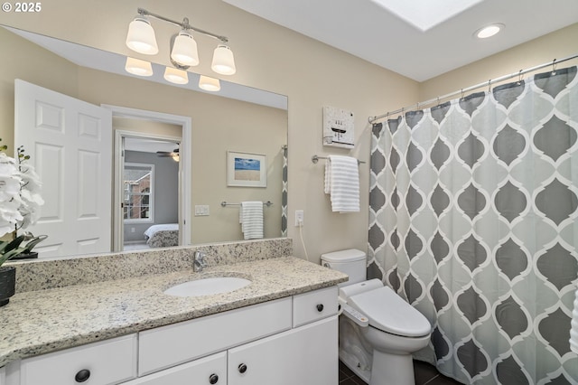 bathroom featuring vanity, a shower with shower curtain, toilet, and ensuite bathroom