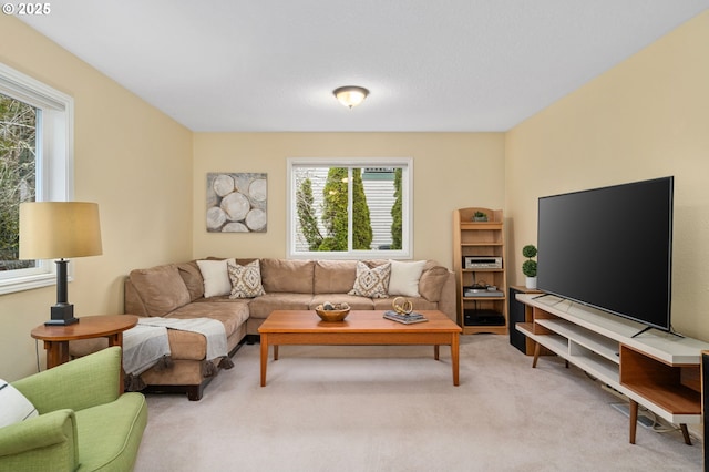 living area featuring light carpet