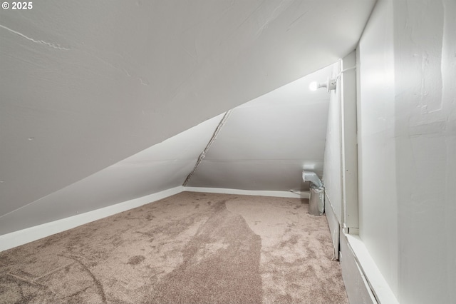 bonus room featuring vaulted ceiling, carpet flooring, and baseboards