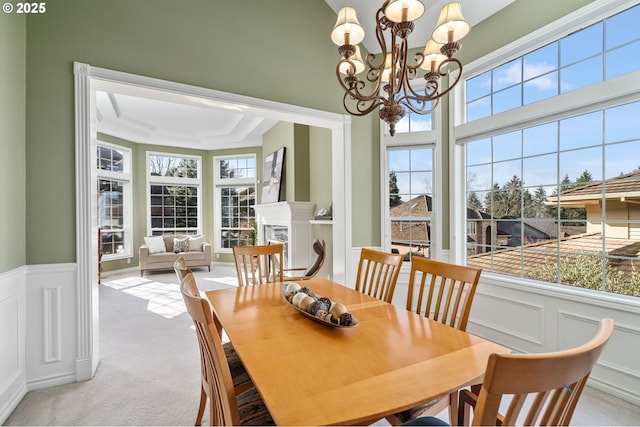 dining room with plenty of natural light, a notable chandelier, and a decorative wall