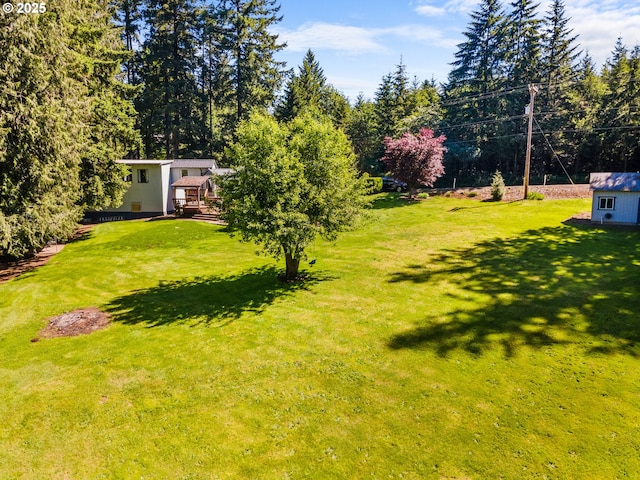 25465 S Beavercreek Rd, Beavercreek, OR 97004 - view of grassy yard featuring a deck and an outbuilding