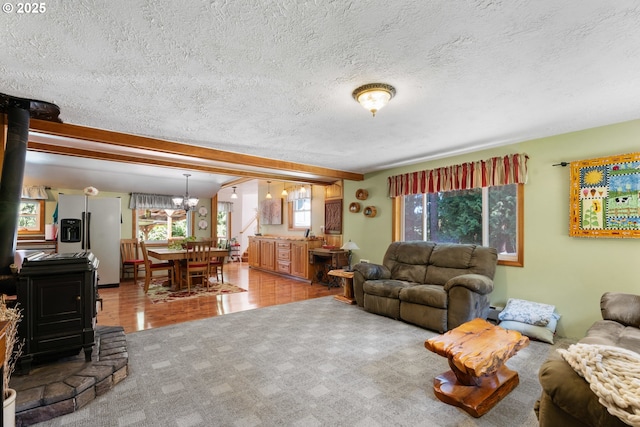 25465 S Beavercreek Rd, Beavercreek, OR 97004 - living area featuring a wood stove, a chandelier, a textured ceiling, light wood-style flooring, and baseboard heating