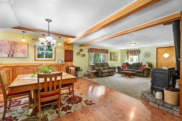 25465 S Beavercreek Rd, Beavercreek, OR 97004 - dining space with a wood stove, a chandelier, wood finished floors, and beamed ceiling