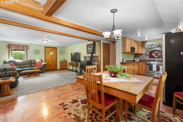 25465 S Beavercreek Rd, Beavercreek, OR 97004 - dining room with light wood finished floors, a chandelier, and beam ceiling