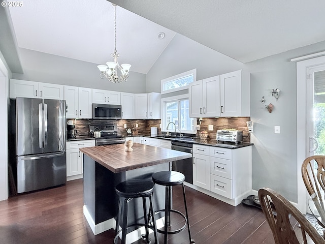 2942 NW Watkins Ct, Camas, WA 98607 - kitchen with appliances with stainless steel finishes, a chandelier, dark wood-type flooring, white cabinets, and wood counters