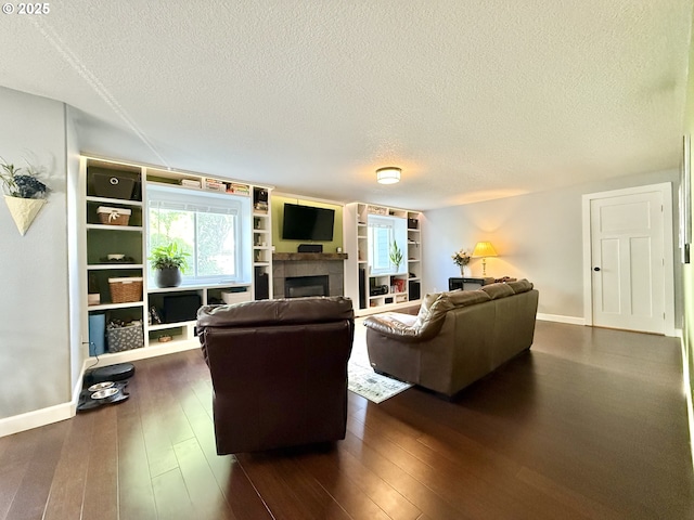 2942 NW Watkins Ct, Camas, WA 98607 - living room with a textured ceiling, a tiled fireplace, and dark wood finished floors