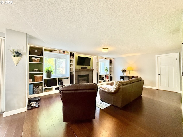 2942 NW Watkins Ct, Camas, WA 98607 - living area featuring a textured ceiling, a tiled fireplace, and dark wood-style floors