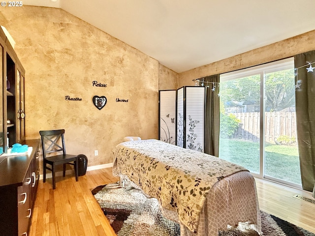 2942 NW Watkins Ct, Camas, WA 98607 - bedroom with vaulted ceiling, hardwood / wood-style floors, access to exterior, and a textured wall