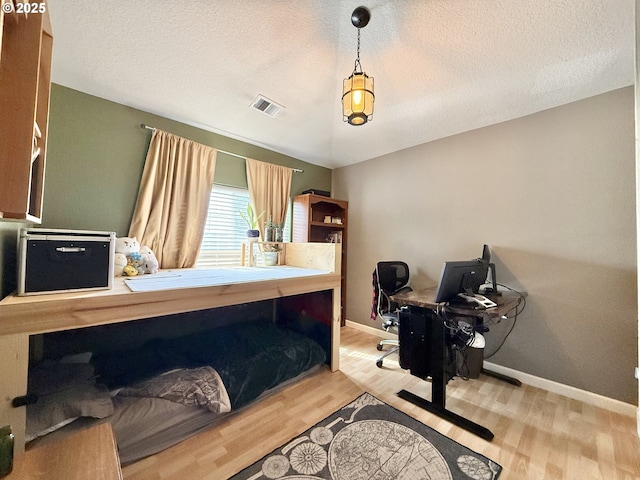 2942 NW Watkins Ct, Camas, WA 98607 - bedroom with an office area, wood finished floors, and a textured ceiling