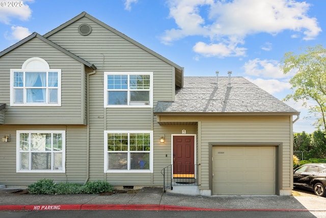 view of front of property featuring aphalt driveway, a shingled roof, and a garage