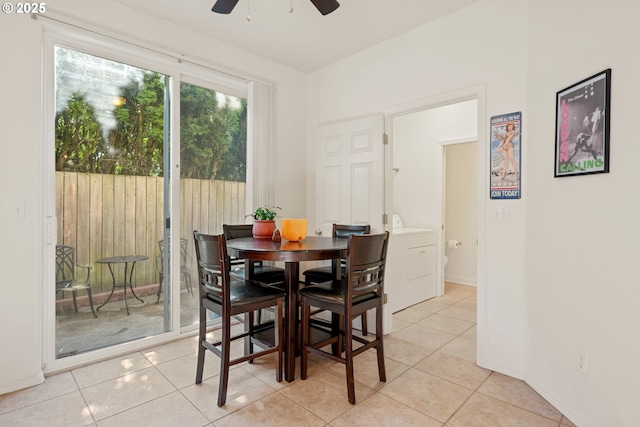 dining area with washer / dryer, light tile patterned floors, ceiling fan, and baseboards