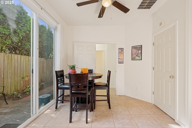 dining area featuring light tile patterned floors, baseboards, ceiling fan, and visible vents