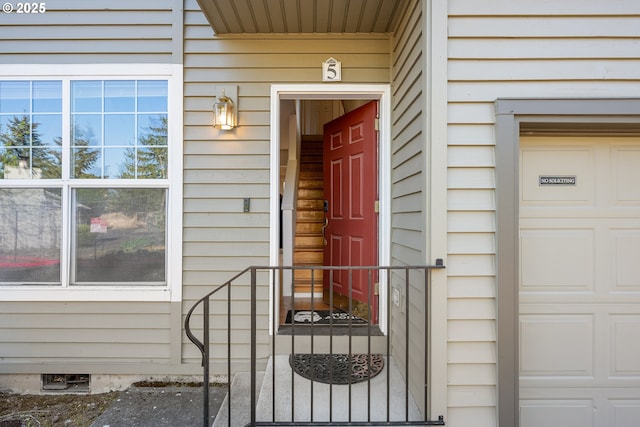 view of exterior entry with a garage